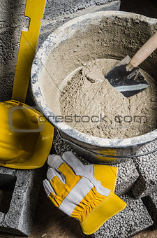 Tools of the mason and  bucket with a solution