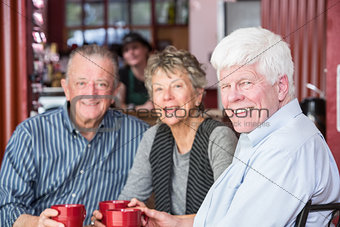 Mature Man with Friends in Coffee House