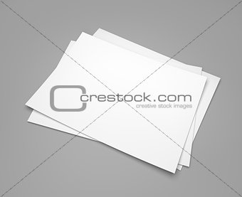 Three white paper sheets on gray