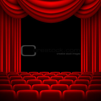 an auditorium with a red curtain
