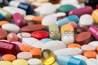Scattered colorful medical pills and drugs