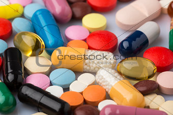 Scattered colorful medical pills and drugs