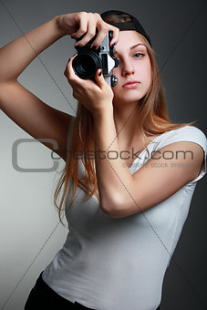 Photographer girl shooting images. Attractive blonde woman takin