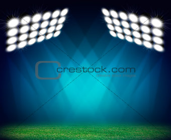 Green soccer field, illuminated spotlights