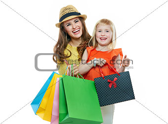 Portrait of smiling mother and daughter with shopping bags