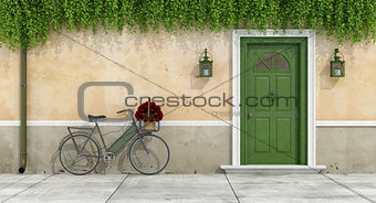 Country house with old door and bicycle