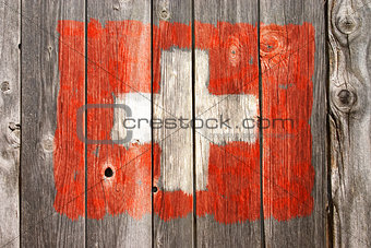 swiss colors on old wooden wound