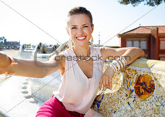 Happy woman taking selfie on famous trencadis style bench