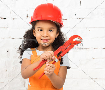 smiling little girl-worker with pliers in hands