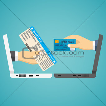 Hands with credit card and airplane ticket.