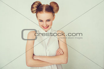 Close-up portrait smiling beautiful girl. with funny hairstyle. Sly and scheming young woman face expression.