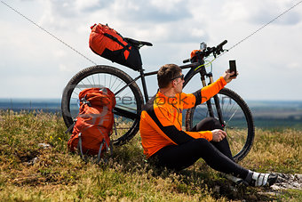Sportive Man Stops Cycling and Has a Rest on Valley
