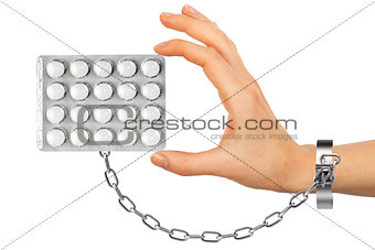 Chained hand with pills