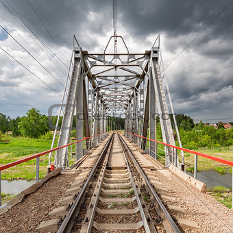 Railway bridge under the stormy skies.