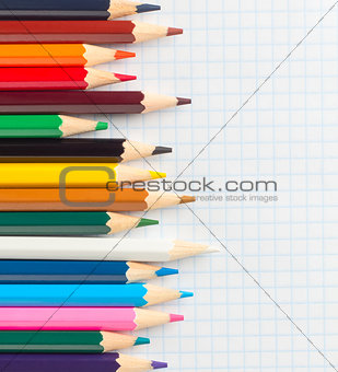 colored pencils on a notebook in the cage