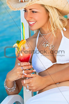 Beautiful Young Woman In Bikini Drinking Cocktail By The Sea