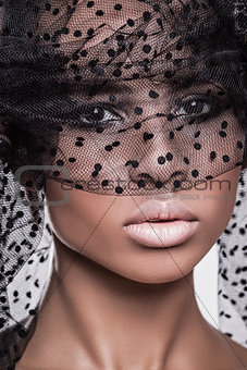 Beautiful american african girl posing with veil