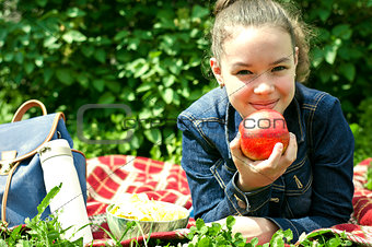 Girl with apple on a plaid