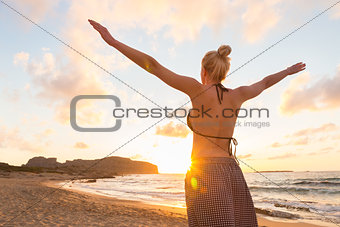 Free Happy Woman Enjoying Sunset on Sandy Beach