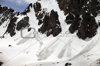 Snowy rocks with traces from avalanche