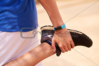 Young Man Sports Stretching Using Fitwatch Steps Counter