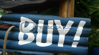 Blue buy sign on wooden block 