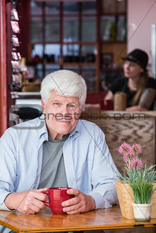 Mature Man in Coffee House