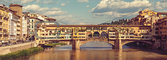 Retro-styled ancient bridge Ponte Vecchio at river Arno