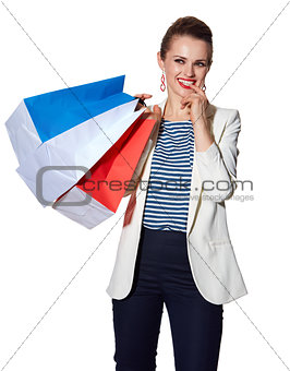 Portrait of pensive woman with French flag colours shopping bags