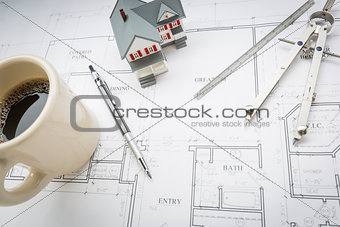 Home, Coffee, Pencil, Ruler and Compass Resting on House Plans