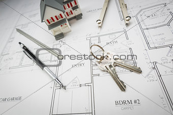 Home, Pencil, Compass, Ruler and Keys Resting On House Plans
