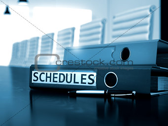 Schedules on Office Binder. Blurred Image.
