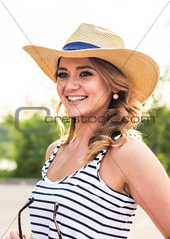 Portrait of elegant lady in hat on summer vacation