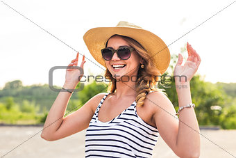 Portrait of laughing girl in hat on summer vacation