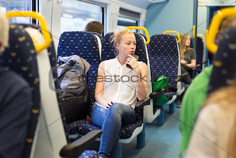 Woman travelling by train.