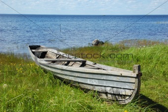 Old fishing boat on the lake bank