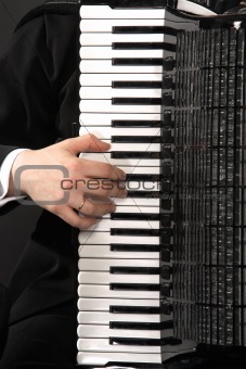 The keyboard of an accordion with a hand