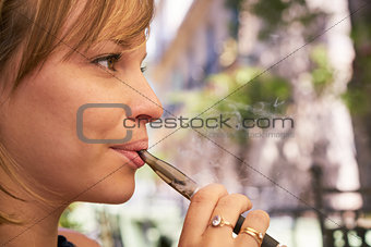 Young Woman Smokes E-Cig Electronic Cigarette