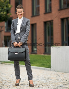 Full length portrait of happy business woman with briefcase