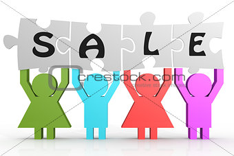 Four people hold puzzle with sale word