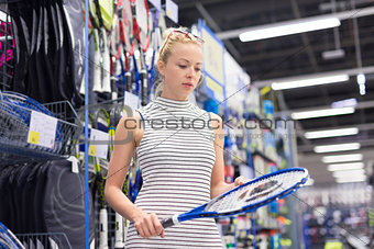 Woman shopping sports equipment in sportswear store.