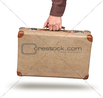 Male hand holding vintage suitcase