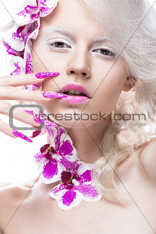 Beautiful girl with art make-up, flowers, curls and long nails. Manicure design. The beauty of the face.