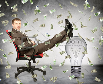 Businessman with light bulb and money rain