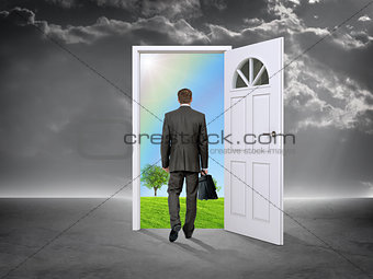 Businessman in grey room with door in nature