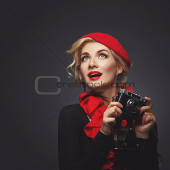 Beautiful lady with retro photo camera