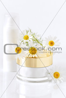chamomile and jars of cream