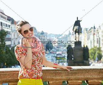 Happy woman talking smartphone at Wenceslas Square in Prague