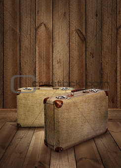 Vintage suitcases on wooden plank background