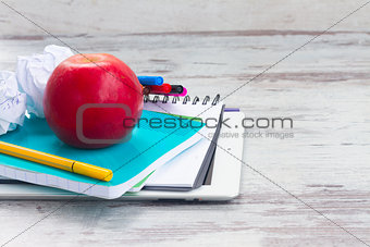 Apple with school supplies